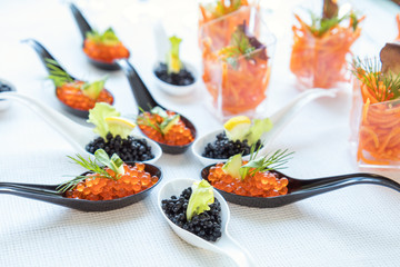 Beautifully decorated catering banquet table with different food salad, caviar on corporate christmas birthday party event or wedding celebration