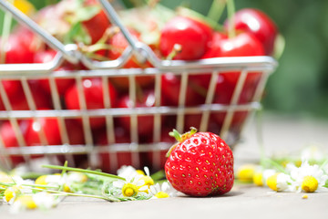 Macro view strawberry, fruit basket and daisy flowers background
