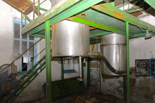 Old milk storage tanks. Premises of a destroyed and plundered milk production plant. The raiders captured the plant. Vandalism. Ukraine, January 2018.