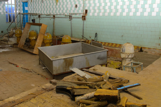 Old equipment for milk production. Premises of a destroyed and plundered milk production plant. The raiders captured the plant. Vandalism. Ukraine, January 2018.