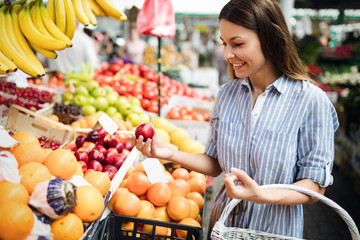 Portrait of beautiful woman holding shopping basket
