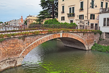 Adria, Rovigo, Veneto, Italy: ancient bridge in the old town of the city near the Po Delta Park - obrazy, fototapety, plakaty