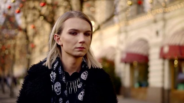 cute gay boy takes place on a Christmas background and Smoking a cigarette