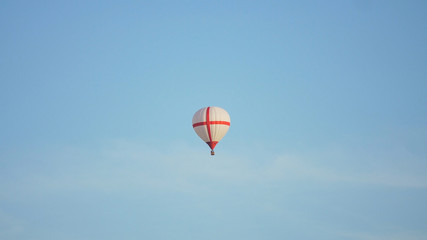 Hot air balloon in the blue sky. Aerostat, Airship. Red balloon.