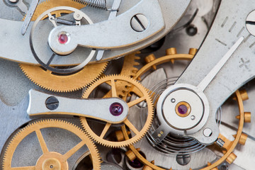 Clock transmission macro view. Stopwatch chronometer mechanism cogs gears wheels connection concept. Shallow depth of field, selective focus