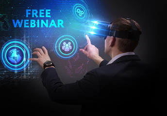 Business, Technology, Internet and network concept. Young businessman working on a virtual screen of the future and sees the inscription: Free webinar