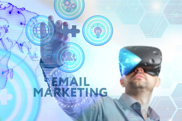 Business, Technology, Internet and network concept. Young businessman working in virtual reality glasses sees the inscription: Email marketing
