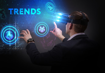 Business, Technology, Internet and network concept. Young businessman working on a virtual screen of the future and sees the inscription: Trends
