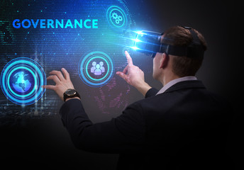 Business, Technology, Internet and network concept. Young businessman working on a virtual screen of the future and sees the inscription: Governance