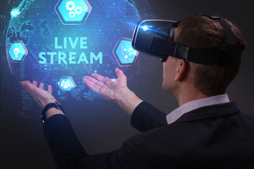 Business, Technology, Internet and network concept. Young businessman working on a virtual screen of the future and sees the inscription: Live stream