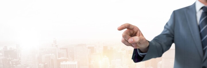 Fototapeta premium Hand pointing with businessman over city