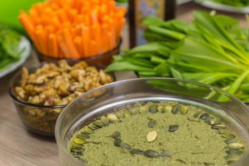 Cooking raw vegan spreads and sauces for a party with a variety of gluten free finger food and healthy snacks rich in vitamins