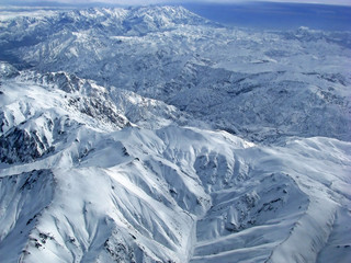 Fototapeta premium Hindu Kush Mountains - snow-covered peaks of mountains seen from the plane