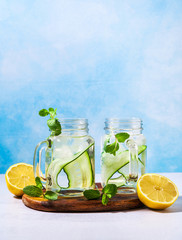 Cold and refreshing infused detox water with lime and cucumber in a glass