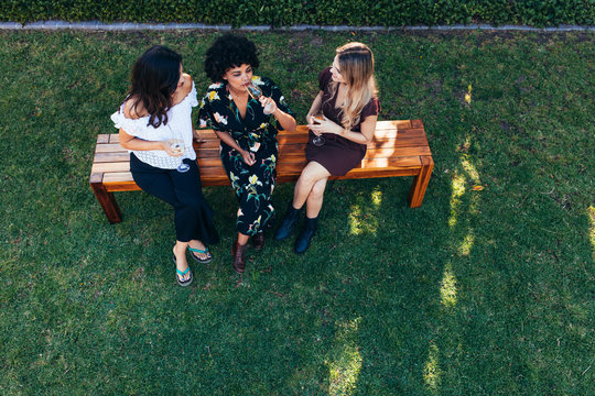 Women Hanging Out With Drinks Outdoors