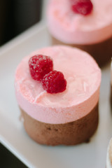 Pink cream cake with berries in restaurant.
