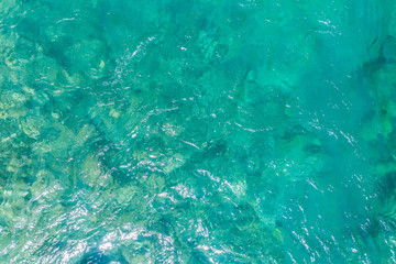 Stony bottom of the river under transparent water 