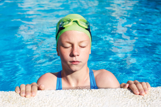 Portrait of little cute child in the swimming pool.Focussed athlete before the start