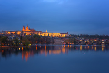 Fototapeta na wymiar Prague, view of illuminated Prague castle (Prazsky Hrad) with reflection in the water, night scenic cityscape, world famous historical heritage of Czech Republic
