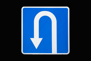 'U-Turn' traffic road sign isolated on black