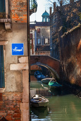 Venice canal with gondola water sign