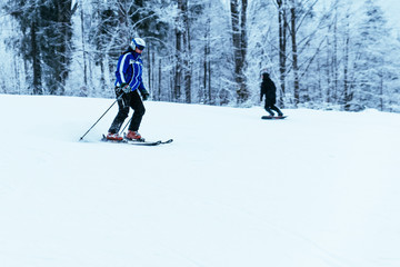 people skiing and snowboarding at winter  mountains