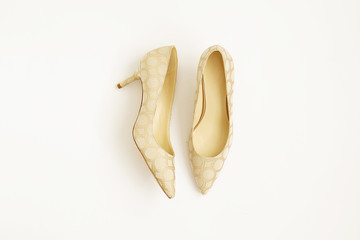 Fashionable medium heeled women's leather wedge shoes isolated on white.