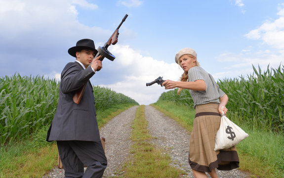 Two models get dressed up in 1930's style vintage fashion clothes and act the role of the gangster duo Bonnie and Clyde.