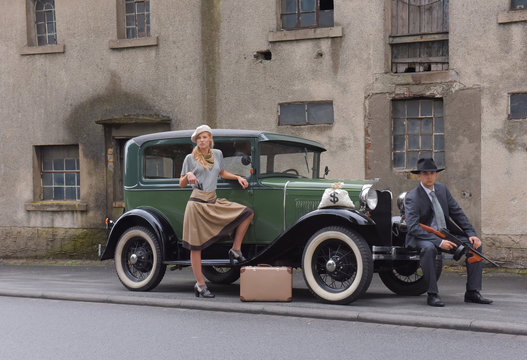 Two models get dressed up in 1930's style vintage fashion clothes and act the role of the gangster duo Bonnie and Clyde.