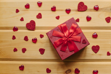 A gift in a beautiful crane box tied with a ribbon on a wooden surface.