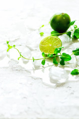 Homemade lime lemonade with cucumber, rosemary and ice, white background. Cold beverage, detox water. Copyspace. Banner