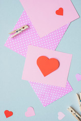 Valentines day background. Valentine card with heart and craft paper on the blue background