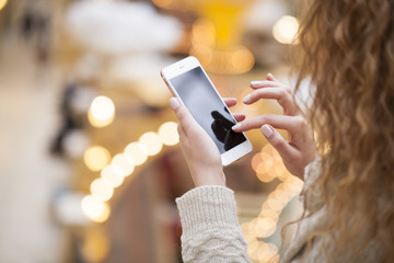 Beautiful female hands holding a mobile phone,