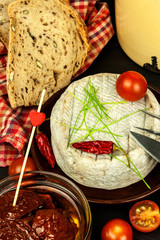 Domestic mature mold cheese. Dairy product. Aromatic cheese with mold.
