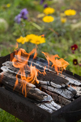 Barbecue grill with glowing coals. Dirty Charcoal Grill on garden background. outddors.