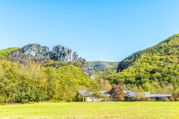 View of Seneca Rocks from visitor center during autumn, golden yellow foliage on trees in forest,...