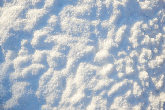 snow for texture or background at sunny day, bright light with shadows, flat lay, top view, clean and nobody