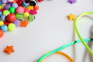 colorful beads and thread on white background