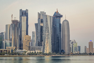  Doha Qatar skyline in west bay area (financial district) with Arabic gulf in foreground daylight view 