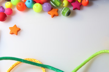 colorful beads and thread on white background