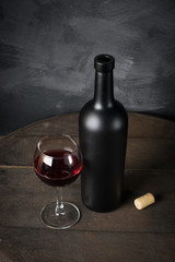 Red wine bottle on a wooden background
