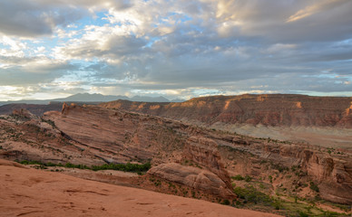 blue sky and clouds over cliffs of Salt Valley at sunrise panoramic view from Delicate Arch
Arches National Park, Moab, Utah