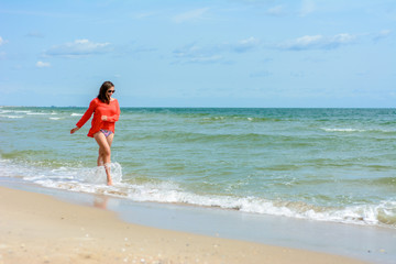 Fototapeta na wymiar A charming woman walks on the Black Sea coast