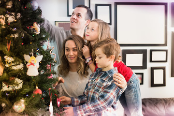 Smiling parents with children preparing for Christmas