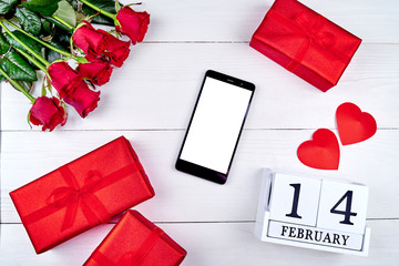Valentines Day background with bouquet of red roses, cellphone with blank screen, paper hearts and february 14 wooden block calendar, copy space. Greeting card mockup. Love concept. Top view, flat lay