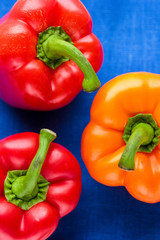 orange and red paprika on a blue background