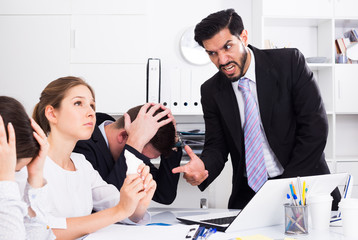 Businessman feeling angry to coworkers in office