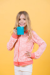 Happy child smiling with mug in hand