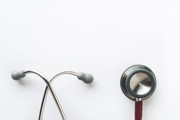 Close up view of a red stethoscope isolated on white background. Medicine or health concept