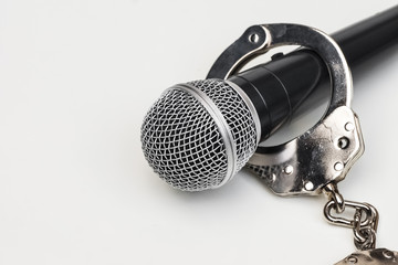 A microphone with handcuffs / Freedom of the press is at risk concept - World press freedom day...